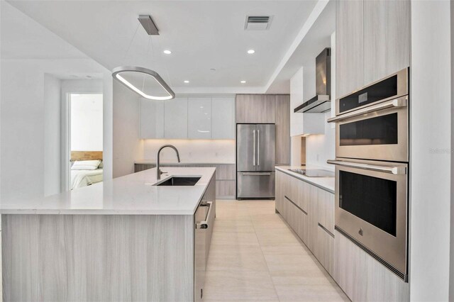 301 Quay Commons Unit 1711, Sarasota, FL 34236 - kitchen featuring modern cabinets, a sink, stainless steel appliances, wall chimney exhaust hood, and light countertops