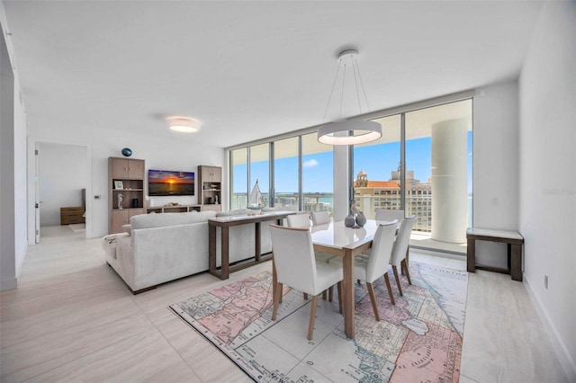 301 Quay Commons Unit 1711, Sarasota, FL 34236 - dining area with a wall of windows and baseboards