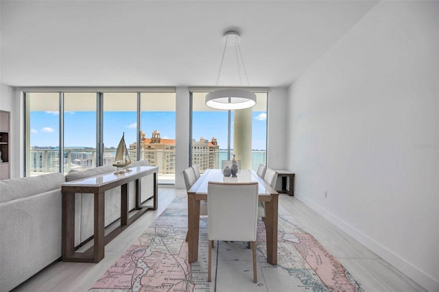 301 Quay Commons Unit 1711, Sarasota, FL 34236 - dining space featuring baseboards and light wood-style floors