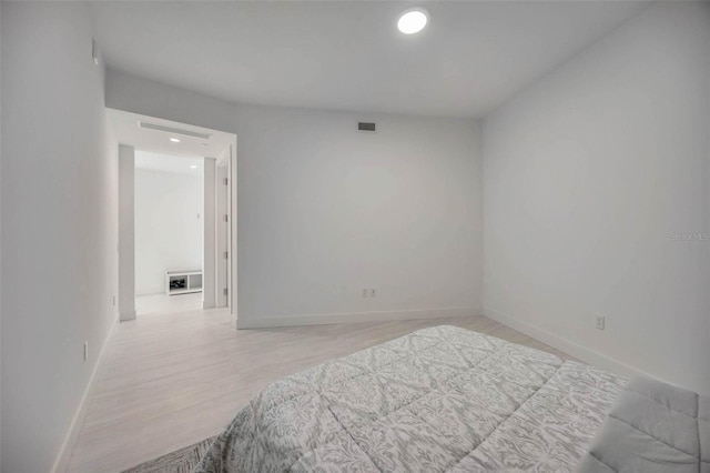 301 Quay Commons Unit 1711, Sarasota, FL 34236 - bedroom featuring recessed lighting, light wood-type flooring, and baseboards