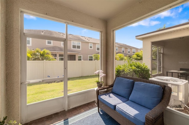 sunroom with an outdoor hangout area and a residential view