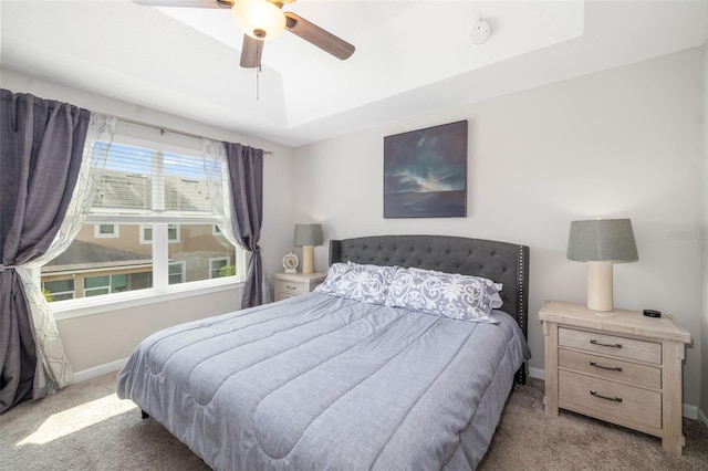 carpeted bedroom with baseboards and a ceiling fan