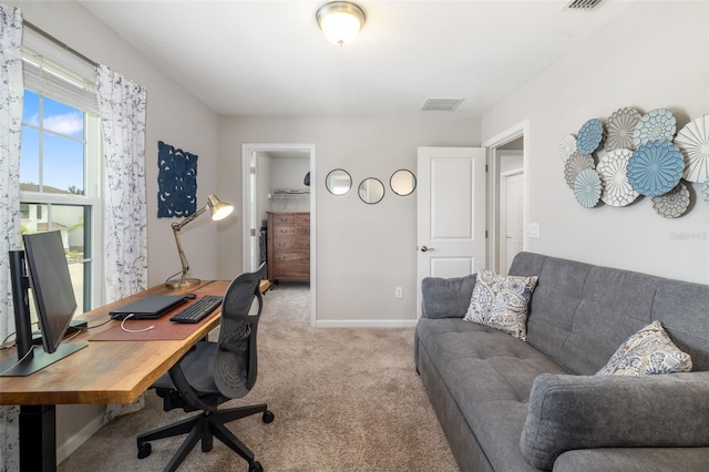 home office with light carpet and baseboards