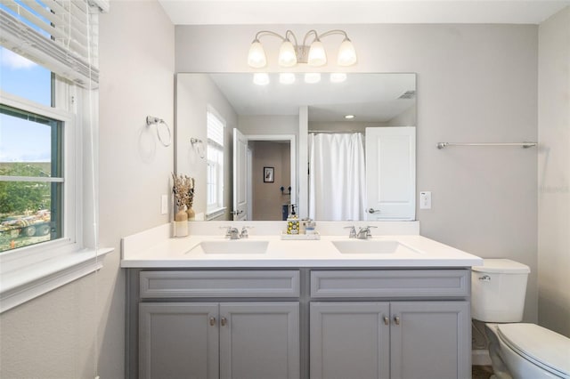 full bath featuring toilet, double vanity, and a shower with shower curtain