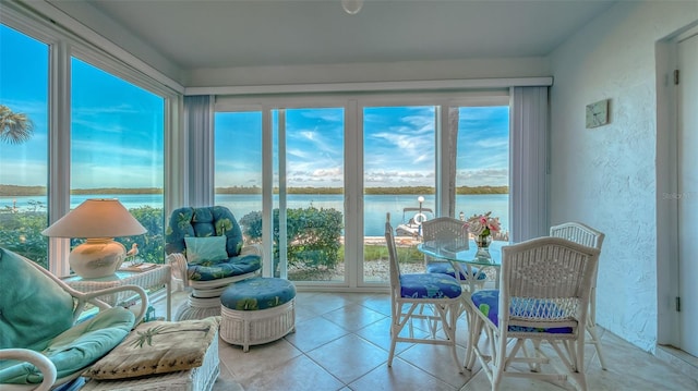 4420 Exeter Dr Unit L104, Longboat Key, FL 34228 - sunroom featuring a water view, tile patterned flooring, and a textured wall