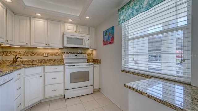 4420 Exeter Dr Unit L104, Longboat Key, FL 34228 - kitchen featuring white appliances, a sink, tasteful backsplash, recessed lighting, and white cabinets