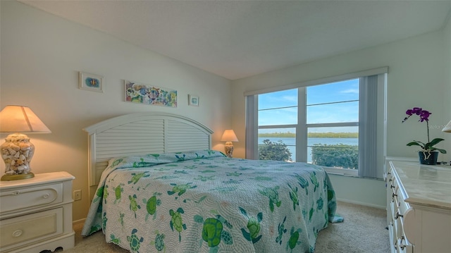 4420 Exeter Dr Unit L104, Longboat Key, FL 34228 - bedroom featuring light carpet, multiple windows, baseboards, and a water view