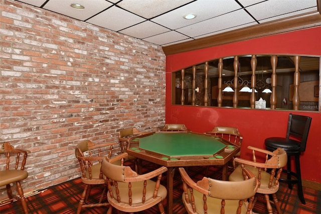 4420 Exeter Dr Unit L104, Longboat Key, FL 34228 - playroom featuring brick wall and a paneled ceiling