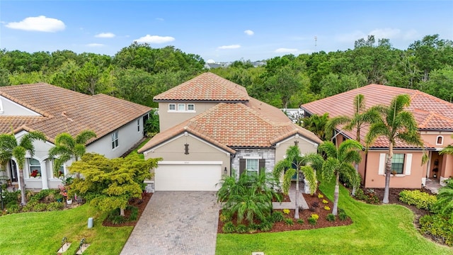 2745 62nd Ave E, Ellenton, FL 34222 - mediterranean / spanish-style house with a garage, a tiled roof, stucco siding, driveway, and a front lawn
