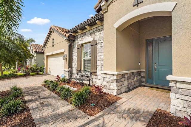 2745 62nd Ave E, Ellenton, FL 34222 - entrance to property featuring stone siding, stucco siding, a garage, and a tile roof
