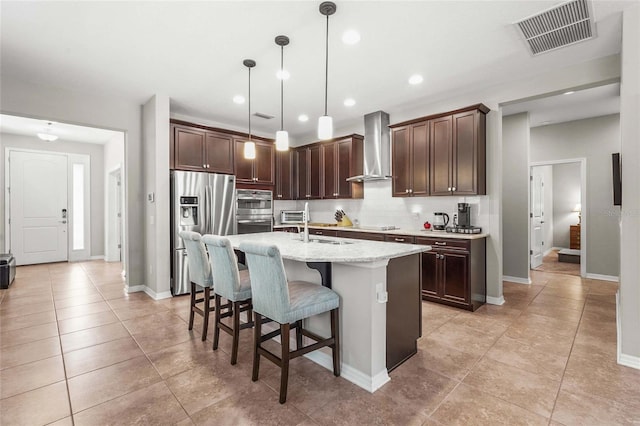 2745 62nd Ave E, Ellenton, FL 34222 - kitchen with stainless steel appliances, wall chimney exhaust hood, tasteful backsplash, a breakfast bar, and dark brown cabinets