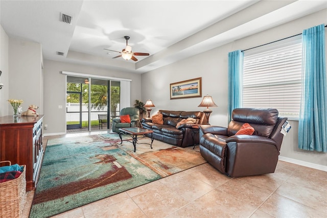 2745 62nd Ave E, Ellenton, FL 34222 - living area with a ceiling fan, a tray ceiling, baseboards, and tile patterned flooring