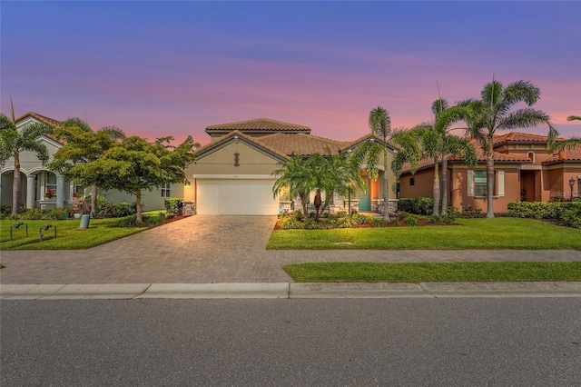 2745 62nd Ave E, Ellenton, FL 34222 - mediterranean / spanish home featuring stucco siding, decorative driveway, a garage, and a front yard