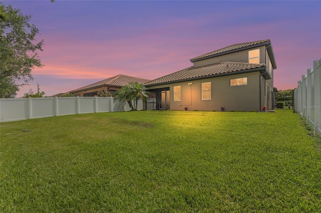 2745 62nd Ave E, Ellenton, FL 34222 - back of house at dusk with a tiled roof and stucco siding