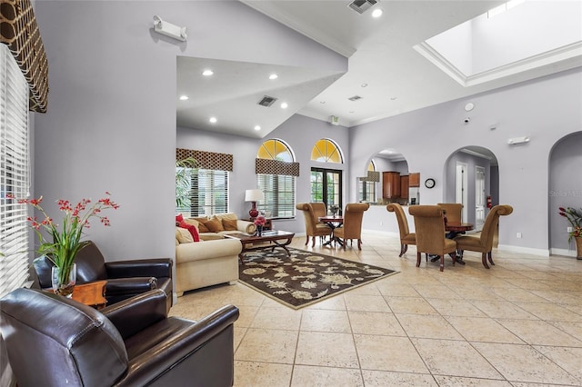 2745 62nd Ave E, Ellenton, FL 34222 - living room featuring arched walkways, crown molding, baseboards, a high ceiling, and recessed lighting