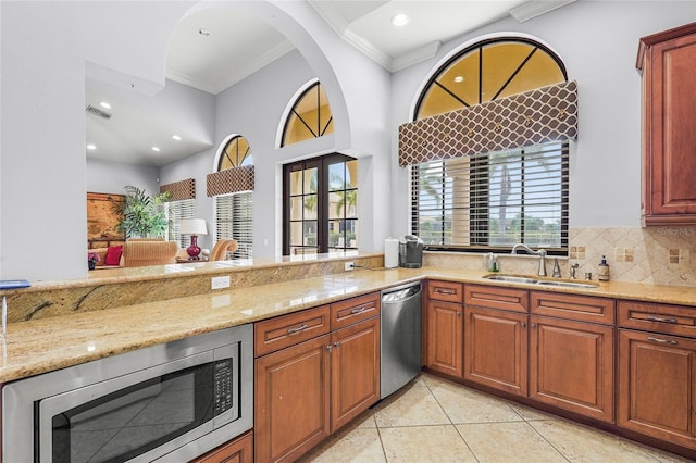 2745 62nd Ave E, Ellenton, FL 34222 - kitchen with stainless steel appliances, a sink, ornamental molding, light stone counters, and recessed lighting