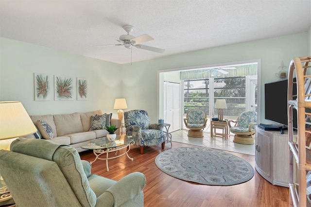 7301 29th Avenue Dr W Unit 108, Bradenton, FL 34209 - living room featuring ceiling fan, wood finished floors, and a textured ceiling