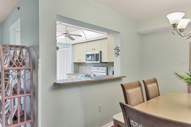 7301 29th Avenue Dr W Unit 108, Bradenton, FL 34209 - dining room featuring ceiling fan and a chandelier