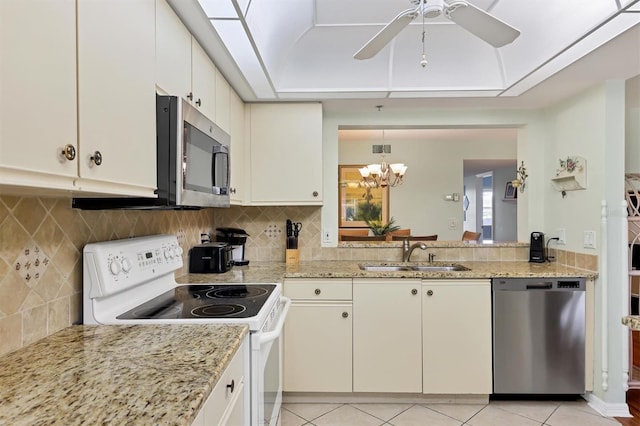 7301 29th Avenue Dr W Unit 108, Bradenton, FL 34209 - kitchen with appliances with stainless steel finishes, a sink, ceiling fan, backsplash, and a chandelier