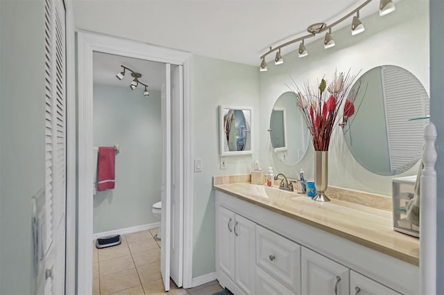 7301 29th Avenue Dr W Unit 108, Bradenton, FL 34209 - bathroom with rail lighting, vanity, toilet, and tile patterned floors