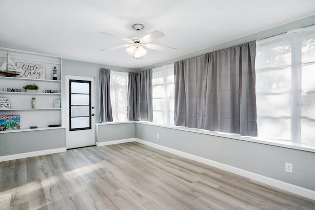 3303 32nd St W, Bradenton, FL 34205 - spare room with wood finished floors, a ceiling fan, and baseboards