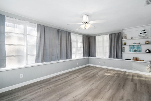 3303 32nd St W, Bradenton, FL 34205 - unfurnished room with ceiling fan, healthy amount of natural light, and wood finished floors