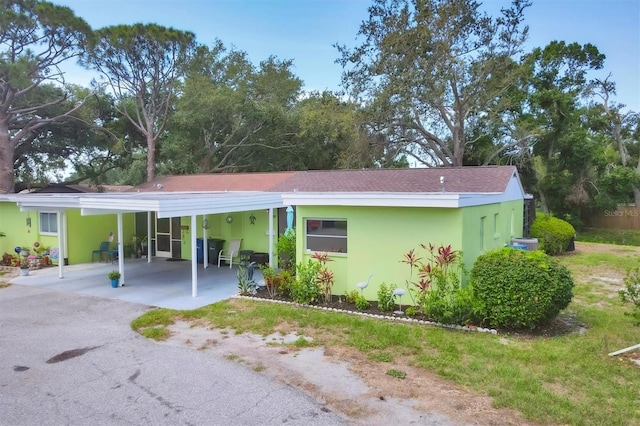 3500 Green View Ct Unit 45, Sarasota, FL 34231 - view of front facade featuring driveway, a carport, stucco siding, and a shingled roof