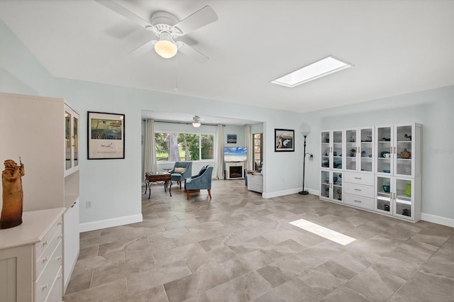 3500 Green View Ct Unit 45, Sarasota, FL 34231 - interior space featuring ceiling fan, a skylight, baseboards, and light stone finish floors