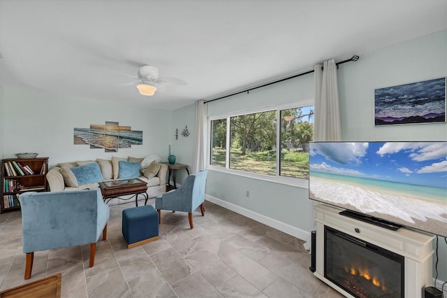 3500 Green View Ct Unit 45, Sarasota, FL 34231 - living room featuring baseboards, a glass covered fireplace, and a ceiling fan