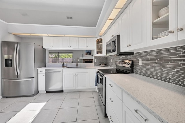 4079 Woodview Dr, Sarasota, FL 34232 - kitchen with stainless steel appliances, a sink, glass insert cabinets, and backsplash