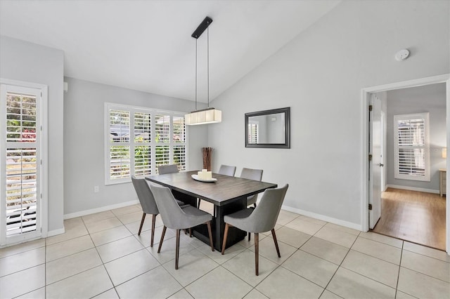 4079 Woodview Dr, Sarasota, FL 34232 - dining space with vaulted ceiling, baseboards, and light tile patterned floors