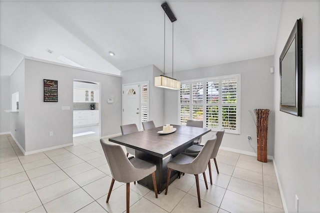 4079 Woodview Dr, Sarasota, FL 34232 - dining space featuring lofted ceiling, light tile patterned floors, and baseboards