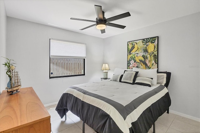 4079 Woodview Dr, Sarasota, FL 34232 - bedroom with light tile patterned floors, baseboards, and a ceiling fan