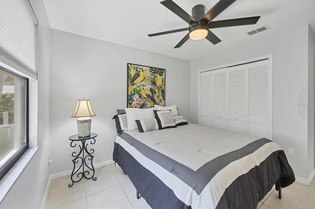 4079 Woodview Dr, Sarasota, FL 34232 - bedroom featuring light tile patterned floors, baseboards, a closet, and a ceiling fan