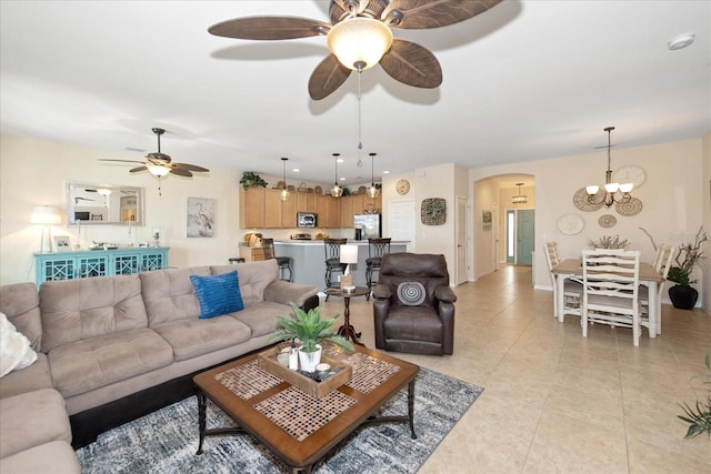 3230 Magnolia Landing Ln, North Fort Myers, FL 33917 - living area featuring a ceiling fan, arched walkways, light tile patterned floors, and a chandelier