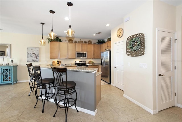 3230 Magnolia Landing Ln, North Fort Myers, FL 33917 - kitchen featuring stainless steel appliances, a kitchen bar, a peninsula, light tile patterned floors, and light stone countertops