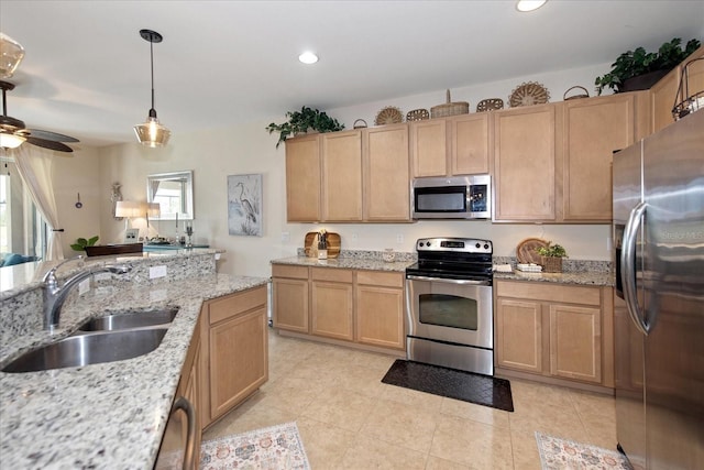 3230 Magnolia Landing Ln, North Fort Myers, FL 33917 - kitchen with appliances with stainless steel finishes, a sink, light brown cabinets, recessed lighting, and hanging light fixtures
