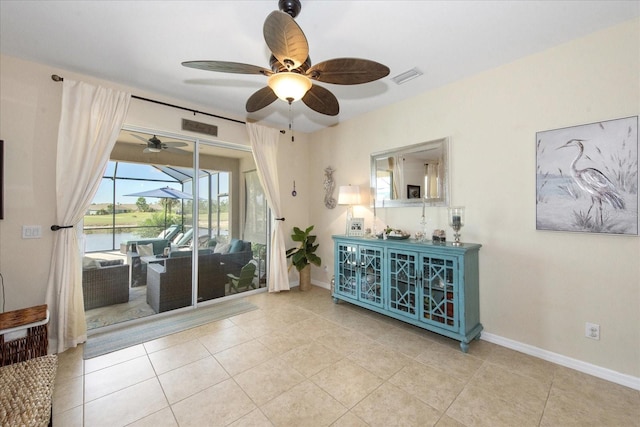 3230 Magnolia Landing Ln, North Fort Myers, FL 33917 - tiled living area with ceiling fan, baseboards, and a water view