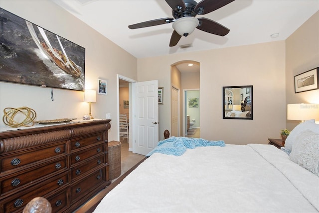 3230 Magnolia Landing Ln, North Fort Myers, FL 33917 - bedroom with arched walkways, ensuite bath, carpet floors, and ceiling fan