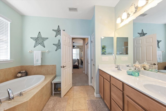 3230 Magnolia Landing Ln, North Fort Myers, FL 33917 - bathroom with ensuite bathroom, a bath, double vanity, and tile patterned flooring