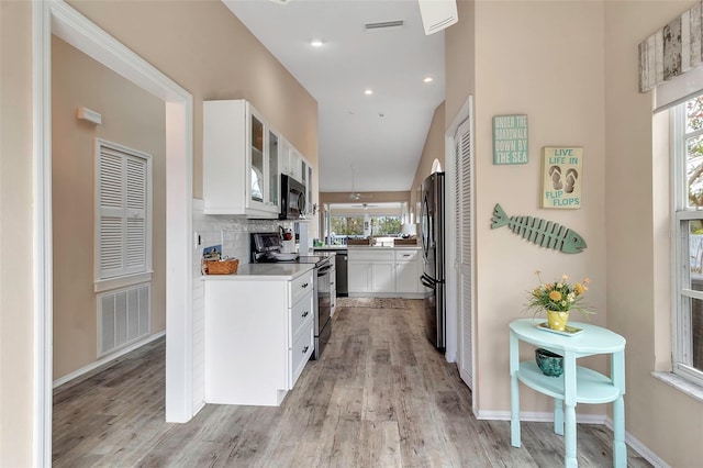 1322 Perico Point Cir, Bradenton, FL 34209 - kitchen featuring range with electric cooktop, black microwave, refrigerator, plenty of natural light, and recessed lighting