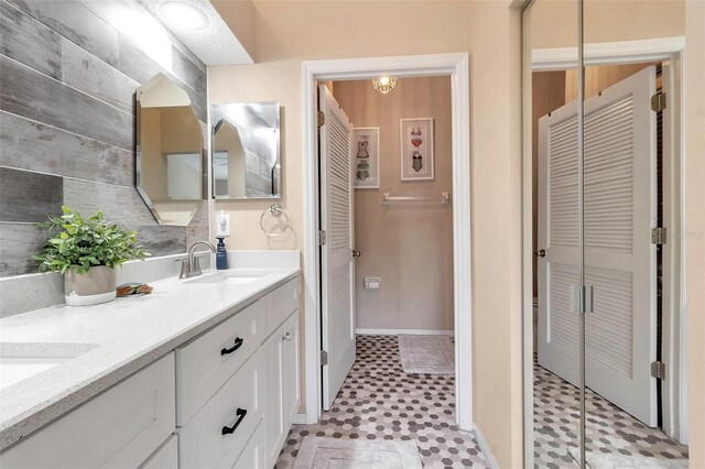 1322 Perico Point Cir, Bradenton, FL 34209 - full bath featuring a closet, double vanity, tile patterned floors, and baseboards
