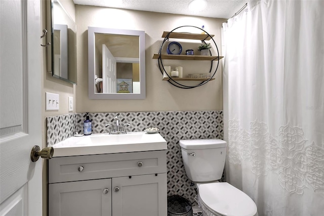1322 Perico Point Cir, Bradenton, FL 34209 - bathroom featuring vanity, toilet, wainscoting, tile walls, and a shower with shower curtain
