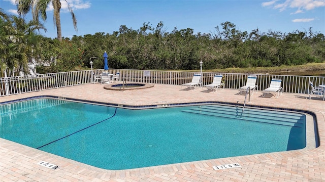 1322 Perico Point Cir, Bradenton, FL 34209 - community pool with a patio, fence, view of scattered trees, and a community hot tub