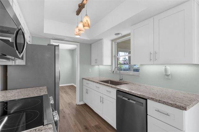 913 64th St W, Bradenton, FL 34209 - kitchen featuring appliances with stainless steel finishes, a sink, white cabinets, and dark wood finished floors