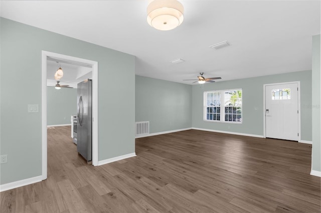 913 64th St W, Bradenton, FL 34209 - unfurnished living room with ceiling fan, wood finished floors, and baseboards
