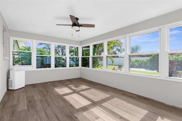 913 64th St W, Bradenton, FL 34209 - unfurnished sunroom featuring wood finished floors and a deck with water view