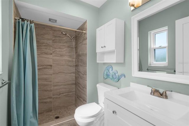 913 64th St W, Bradenton, FL 34209 - bathroom featuring toilet, vanity, and a tile shower