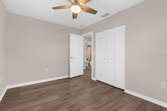 913 64th St W, Bradenton, FL 34209 - unfurnished bedroom featuring wood finished floors, baseboards, a closet, and a ceiling fan