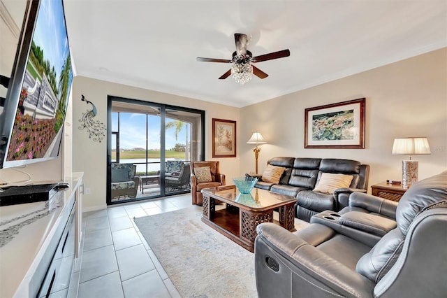 living area featuring ceiling fan, light tile patterned floors, ornamental molding, and baseboards